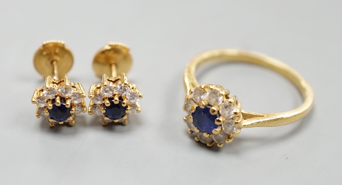 A modern 18ct gold, sapphire and diamond set circular cluster ring, size L and a pair of matching earrings, gross weight 4.6 grams.